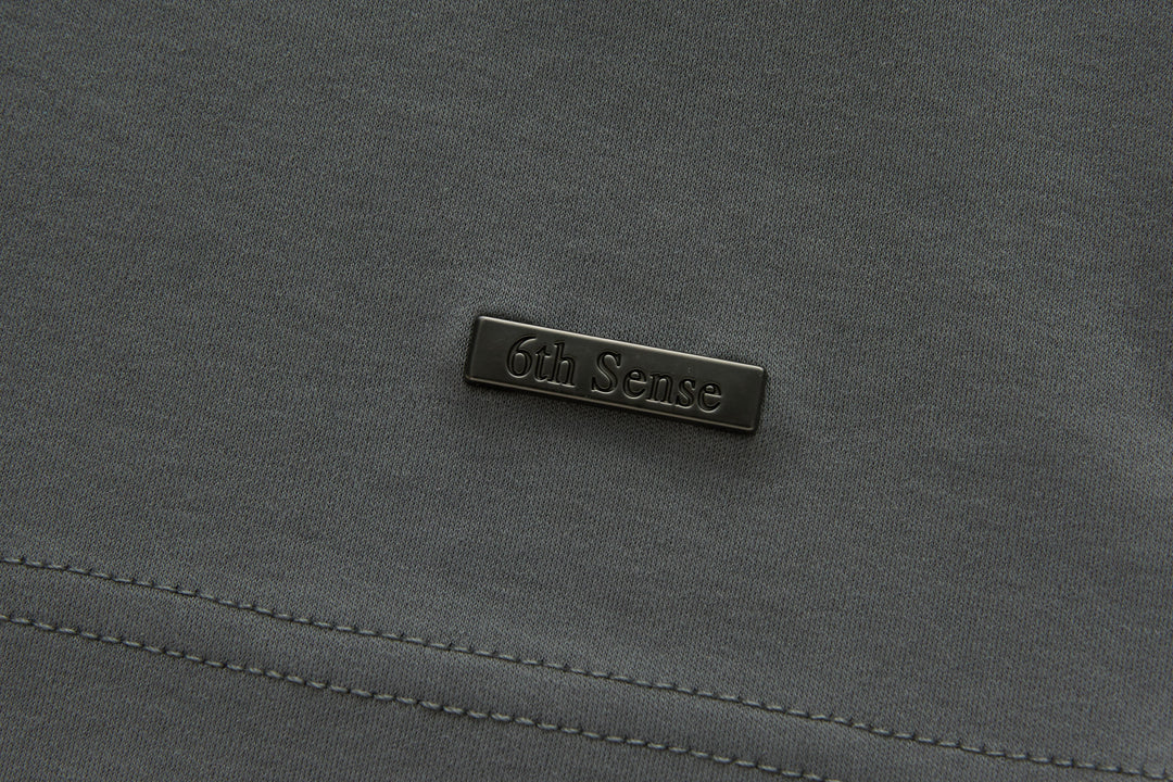 Gray polo shirt chest logo label.