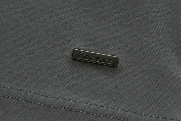 Gray polo shirt chest logo label.