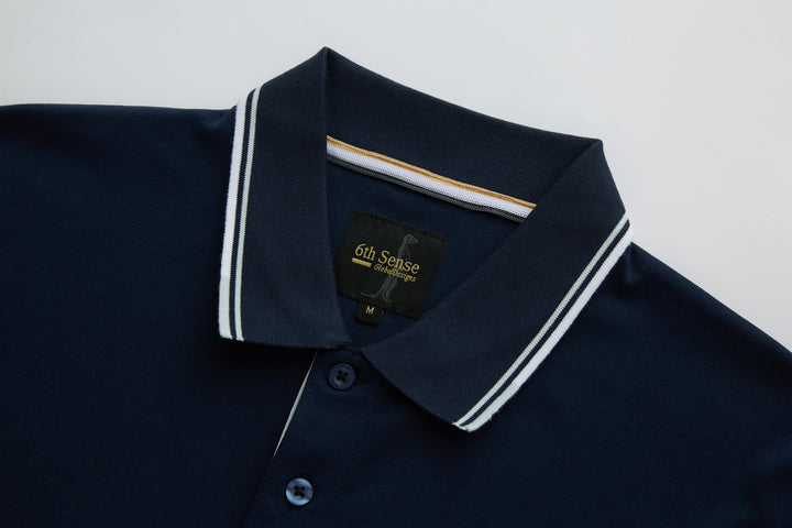 Dark navy polo shirt with striped collar and button placket