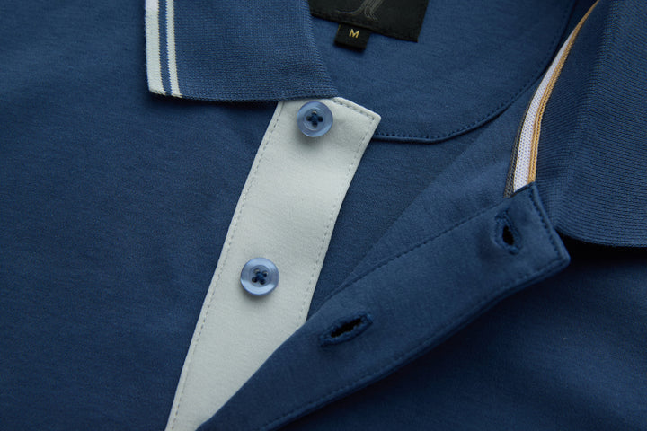 Blue polo shirt with contrast white button placket and dark buttons