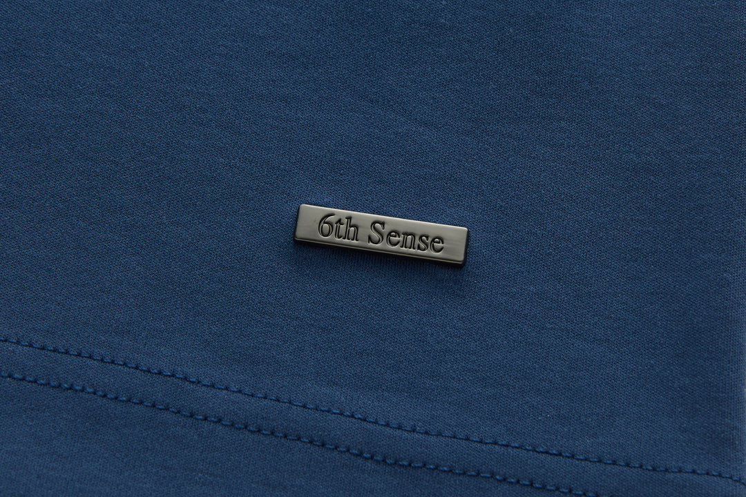 Blue polo shirt with 6th Sense stitched neck label