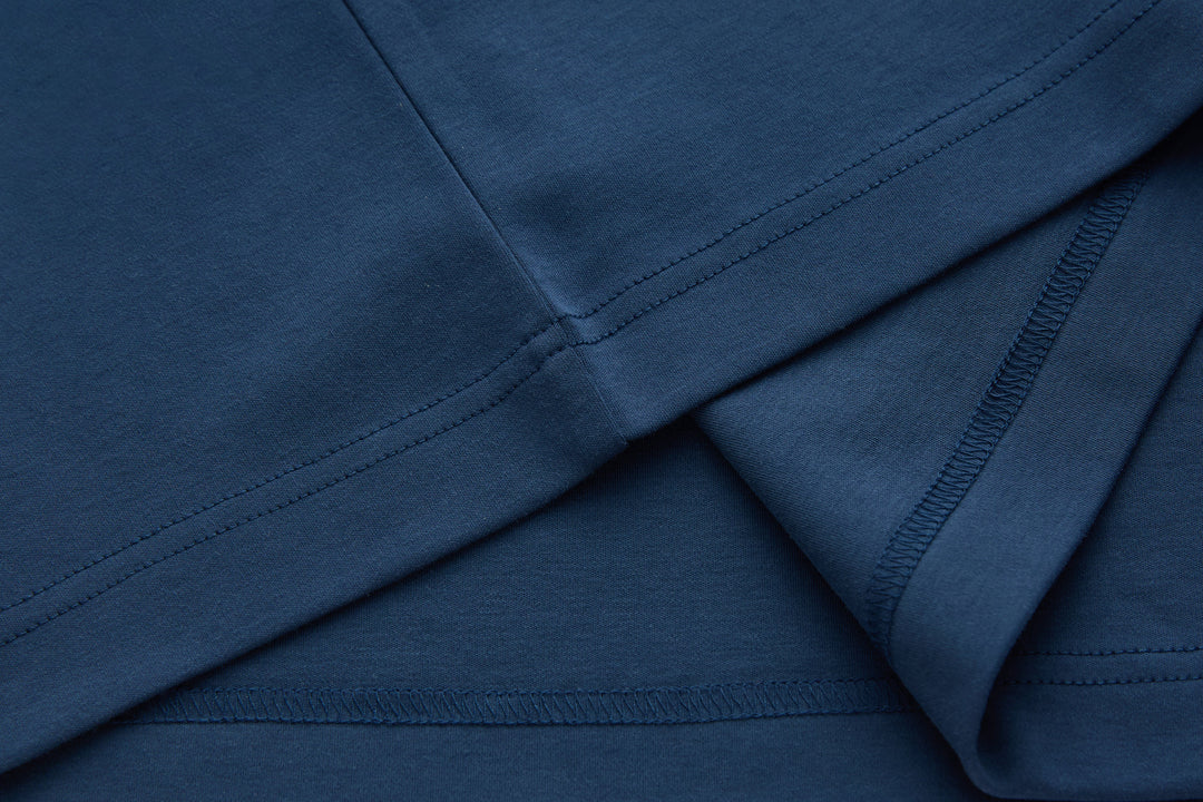 Blue polo shirt side seam and hem stitching detail
