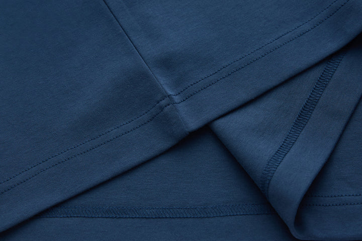 Blue polo shirt side seam and hem stitching detail