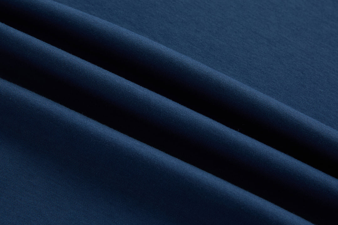Blue polo shirt fabric close-up with smooth knit texture