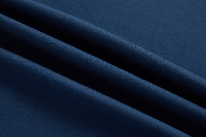 Blue polo shirt fabric close-up with smooth knit texture