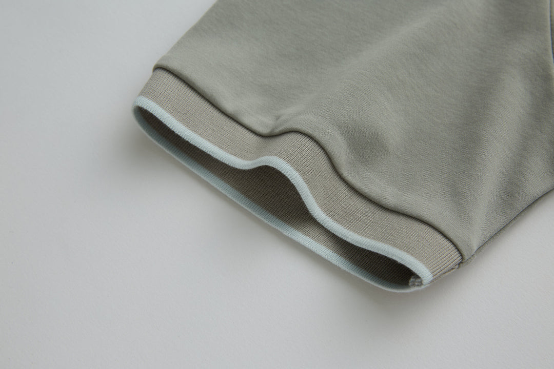Light gray polo shirt hem with ribbed cuff edge detail