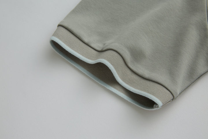 Light gray polo shirt hem with ribbed cuff edge detail