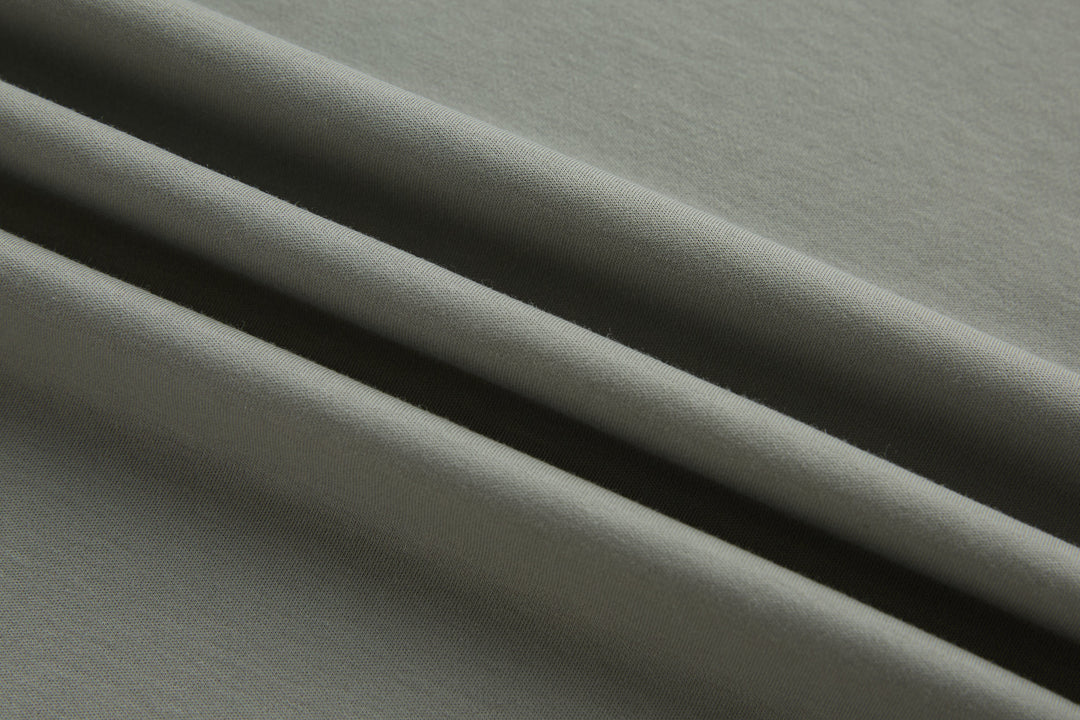 Light gray polo shirt fabric close-up with smooth knit texture