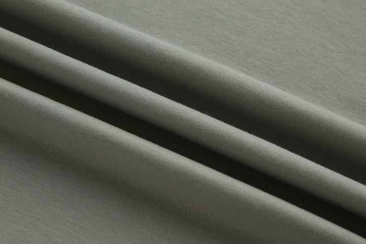 Light gray polo shirt fabric close-up with smooth knit texture