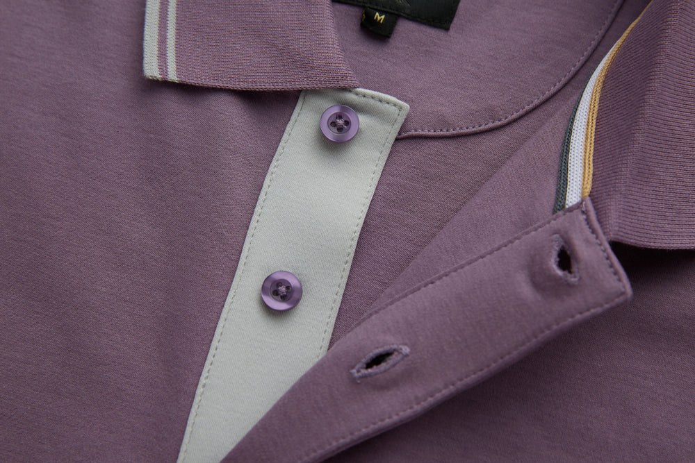 Purple polo shirt placket with white button facing and purple buttons