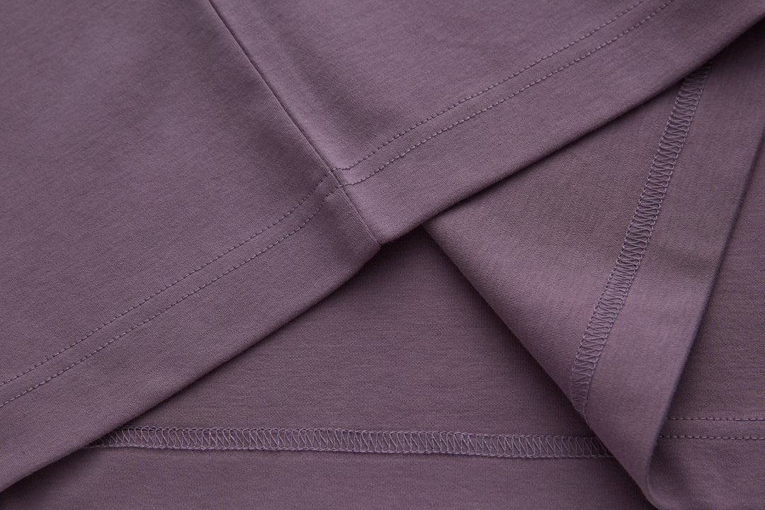 Purple polo shirt fabric panel with contrast edge stitching along seams