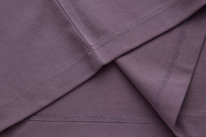Purple polo shirt fabric panel with contrast edge stitching along seams