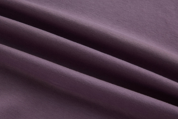 Purple polo shirt fabric close-up with smooth knit texture