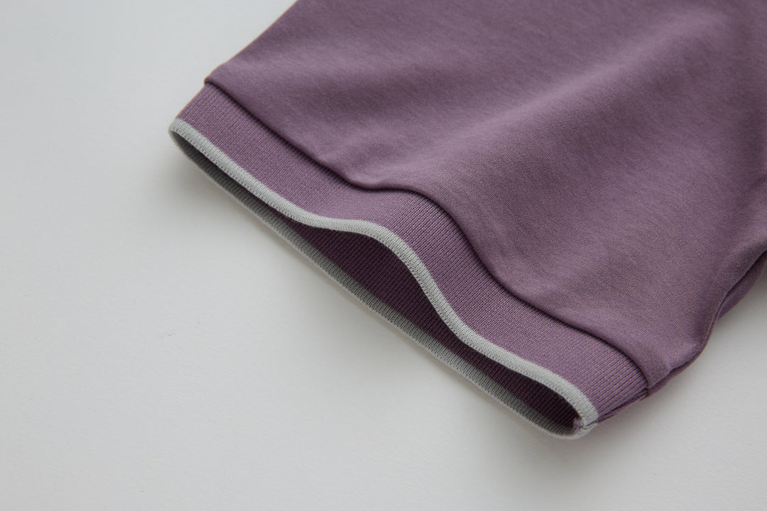 Purple polo shirt sleeve cuff with contrast ribbed hem and stripe trim