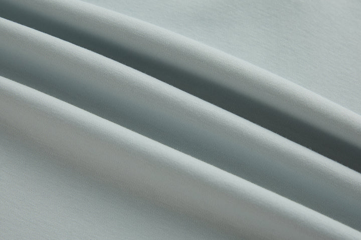 Oyster polo shirt fabric close-up with smooth woven texture
