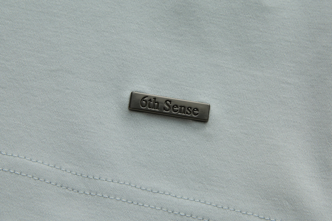 Oyster polo shirt with 6th Sense brand logo patch on chest panel