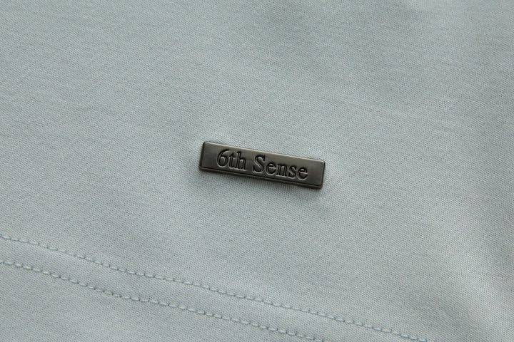 Oyster polo shirt with 6th Sense brand logo patch on chest panel