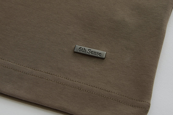 Walnut polo shirt hem with stitched edge and small 6th Sense chest logo