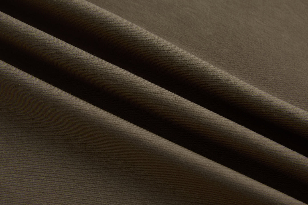 Walnut polo shirt fabric close-up with smooth knit texture