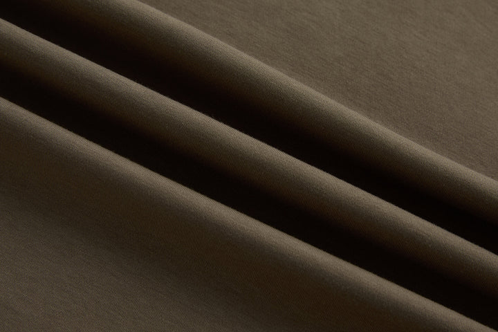 Walnut polo shirt fabric close-up with smooth knit texture
