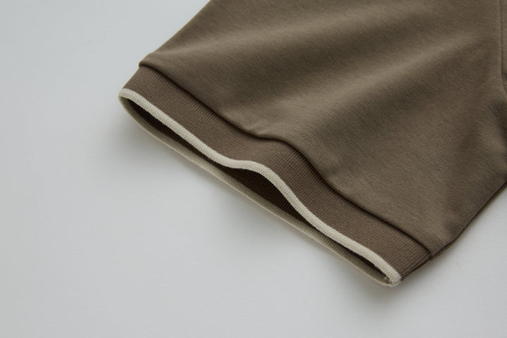 Walnut polo shirt sleeve cuff with ribbed trim and white edge stripe