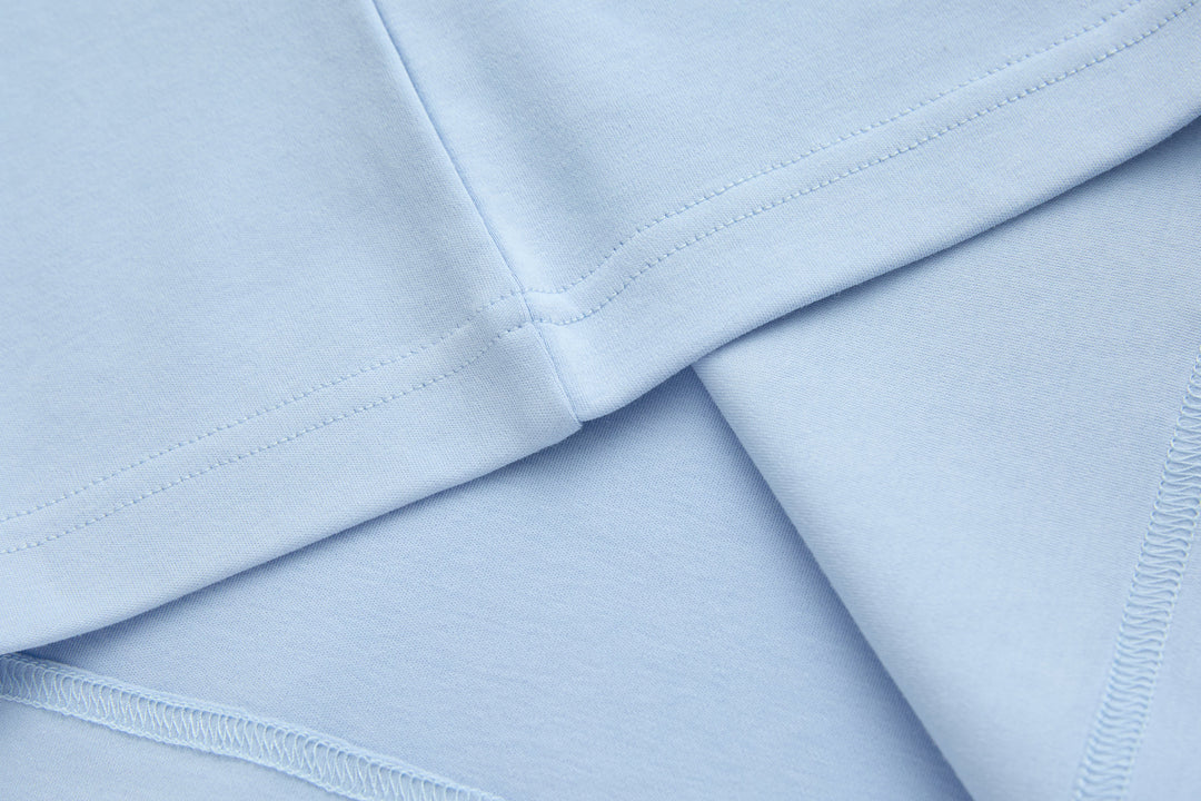 Light blue t-shirt hem and side seams, folded for close-up view