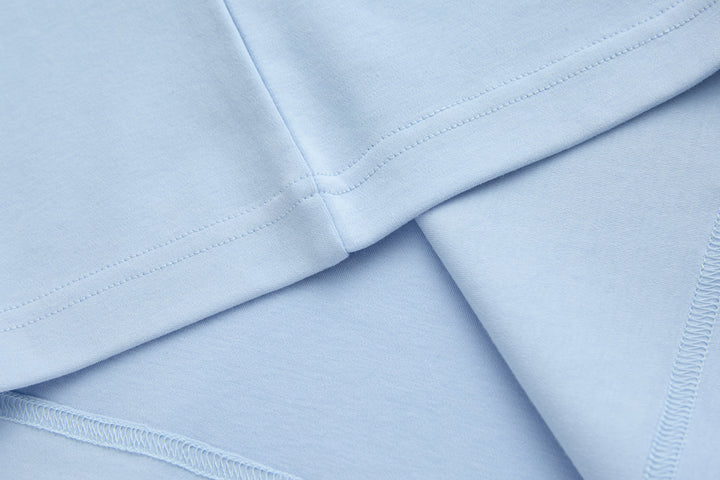 Light blue t-shirt hem and side seams, folded for close-up view