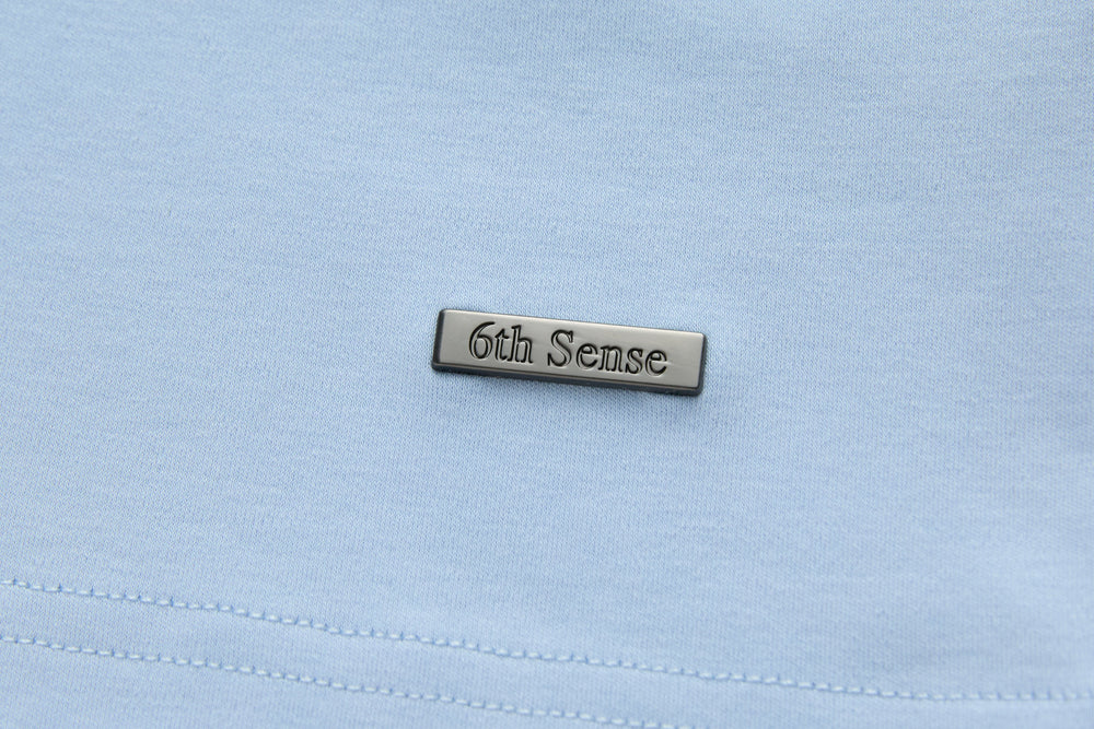 Light blue t-shirt chest label patch with stitched branding
