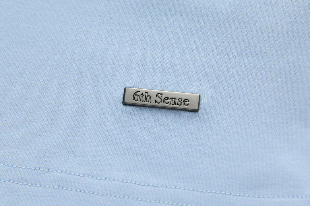 Light blue t-shirt chest label patch with stitched branding
