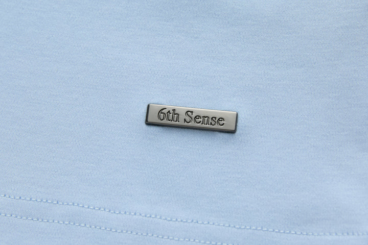 Light blue t-shirt chest label patch with stitched branding