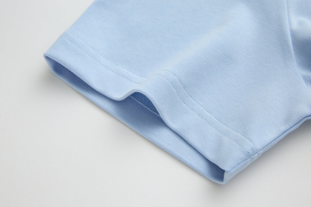 Light blue t-shirt sleeve cuff with double-stitched seam
