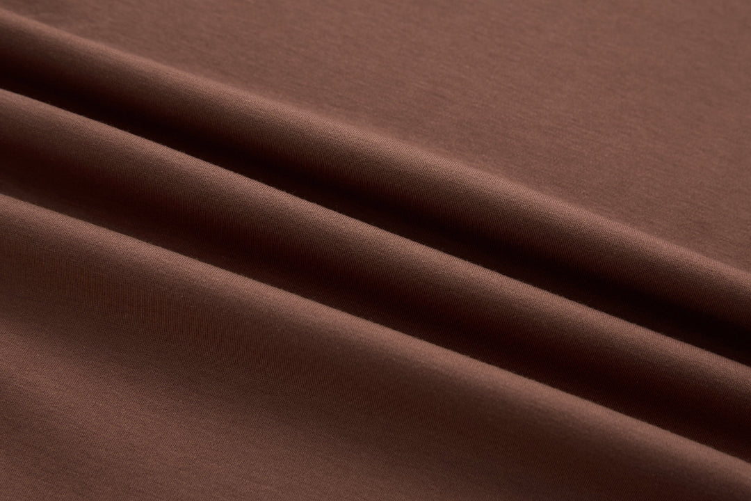 Brown t-shirt fabric close-up with smooth knit texture