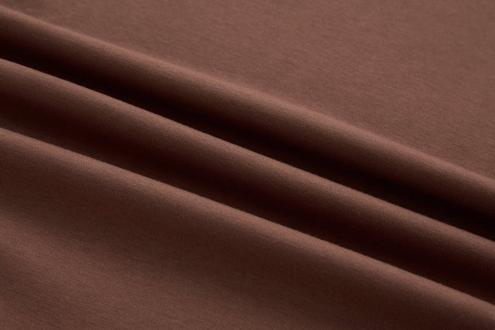 Brown t-shirt fabric close-up with smooth knit texture