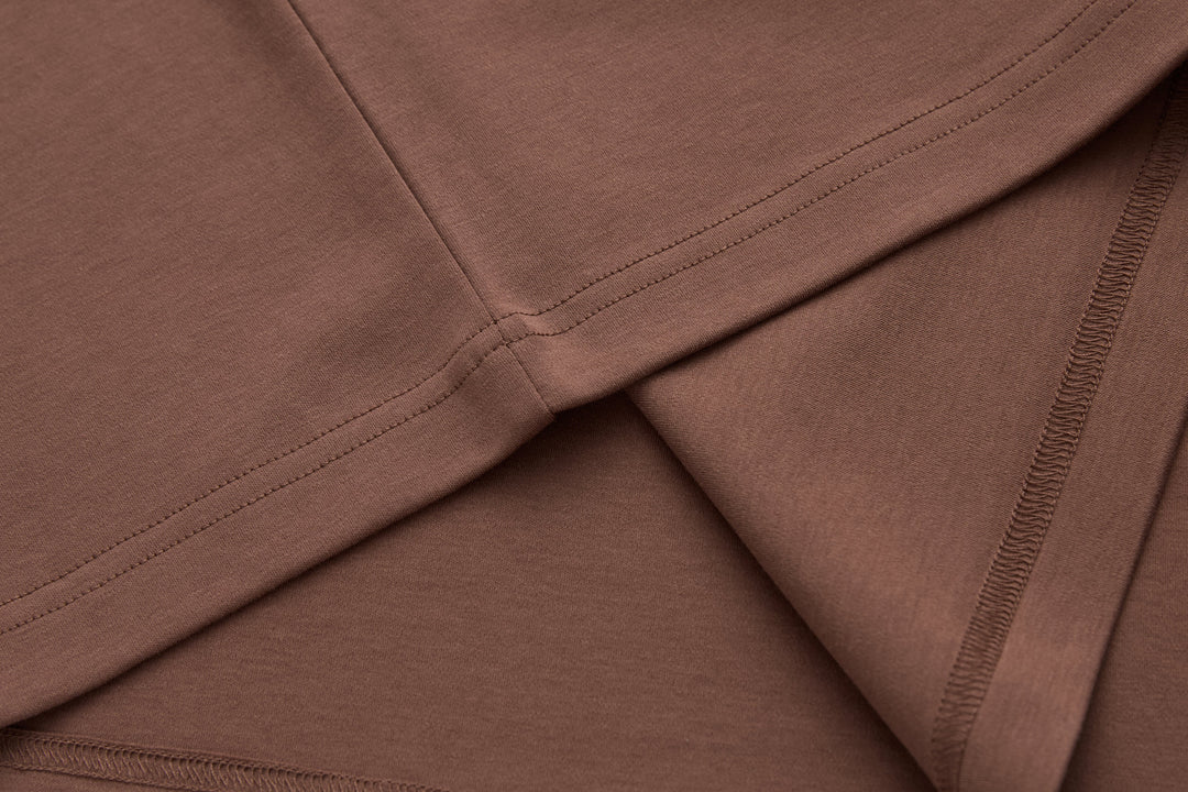 Brown t-shirt stitching and side seam detail at hem