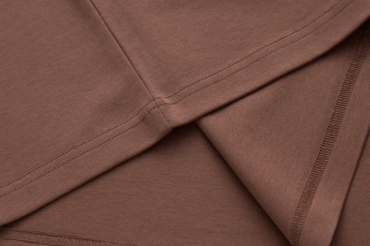 Brown t-shirt stitching and side seam detail at hem