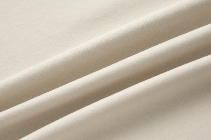Crystal 6th Sense T-shirt fabric close-up, smooth light cream knit