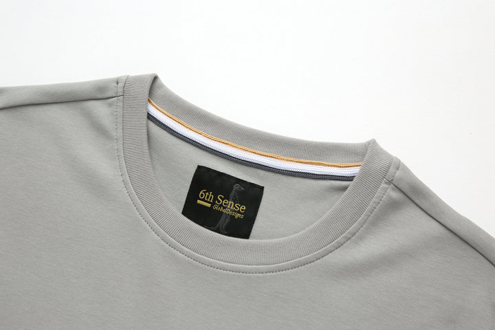 Light gray crewneck T-shirt with ribbed collar and 6th Sense neck label