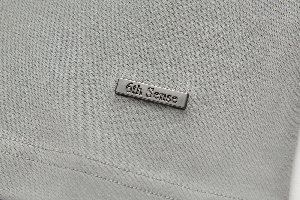 Light gray T-shirt with stitched rectangular 6th Sense chest label