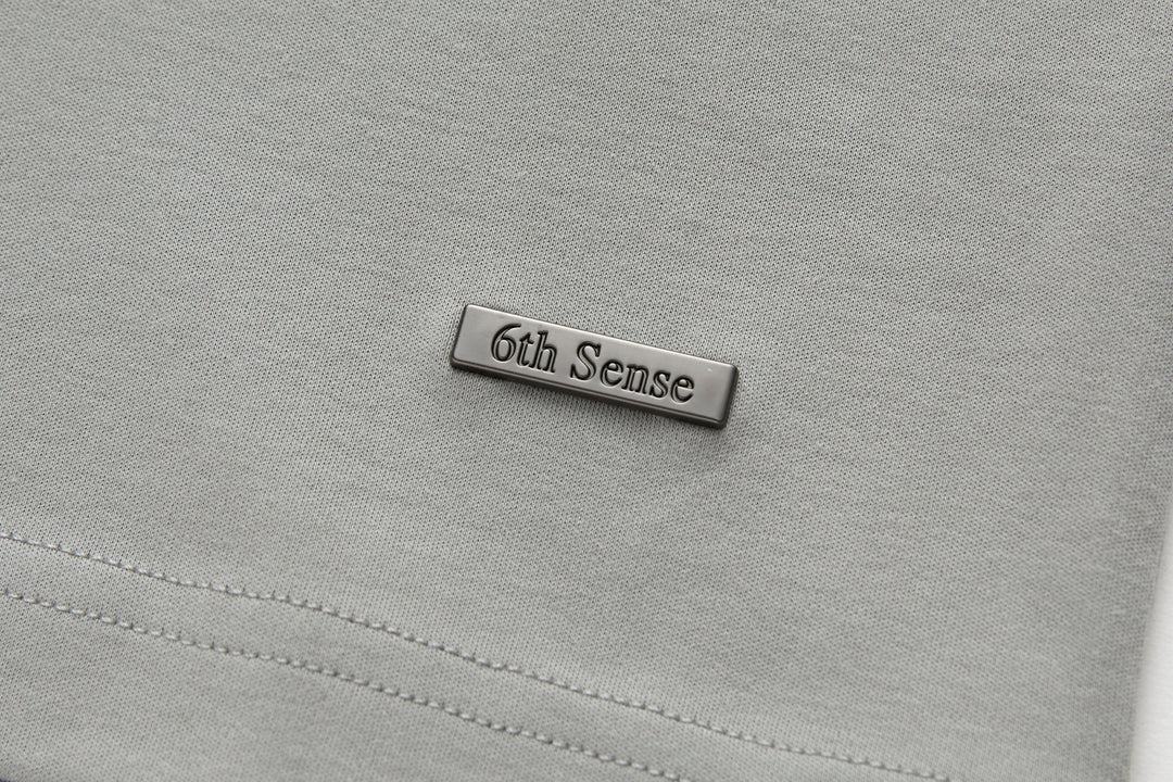 Light gray T-shirt with stitched rectangular 6th Sense chest label