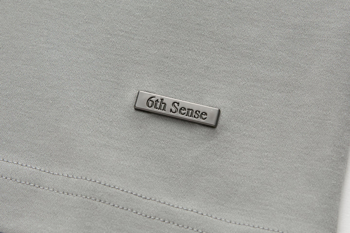 Light gray T-shirt with stitched rectangular 6th Sense chest label