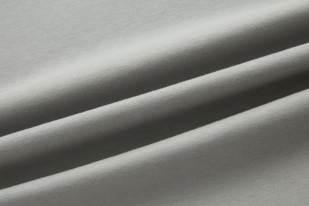 Light gray T-shirt fabric close-up with soft knit texture
