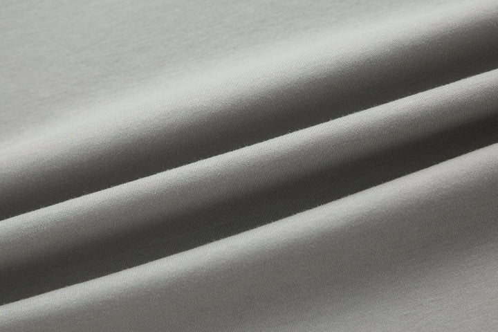 Light gray T-shirt fabric close-up with soft knit texture