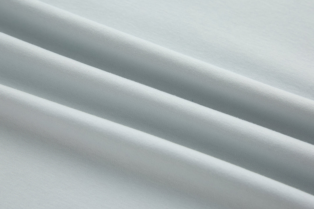 Oyster light blue T-shirt fabric close-up with smooth jersey texture