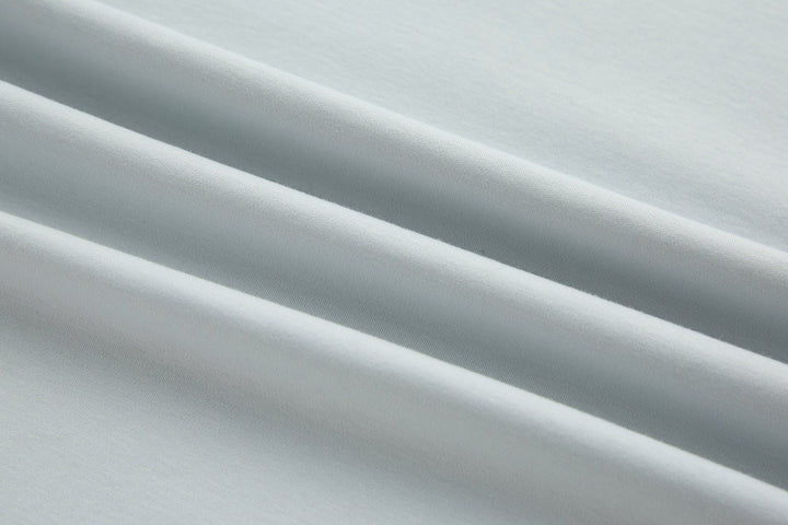Oyster light blue T-shirt fabric close-up with smooth jersey texture