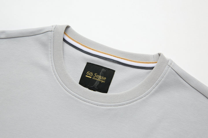 Light gray crew-neck T-shirt with 6th Sense label at collar