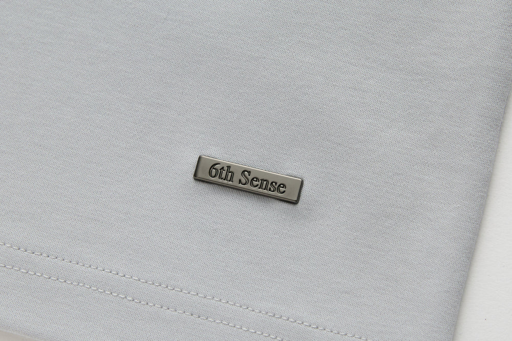 Light gray T-shirt with 6th Sense metal logo patch
