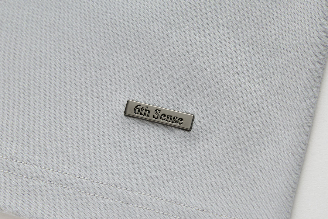 Light gray T-shirt with 6th Sense metal logo patch