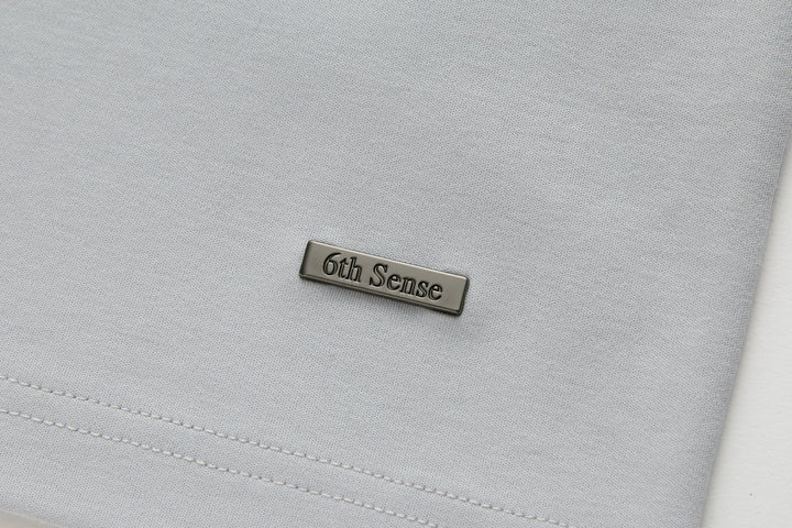 Light gray T-shirt with 6th Sense metal logo patch