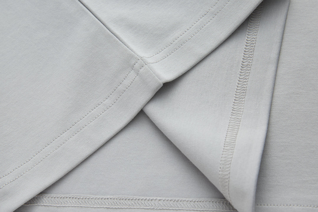 Light gray T-shirt neckline seam with visible stitching close-up