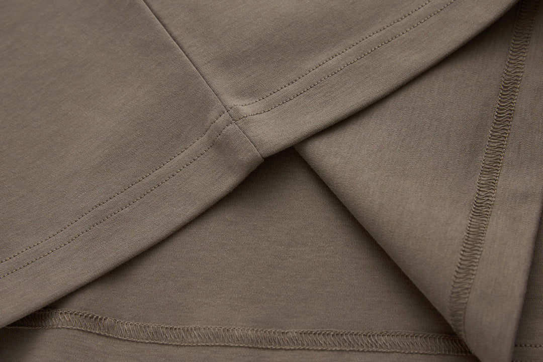 Walnut brown t-shirt sleeve and hem seam stitching close-up